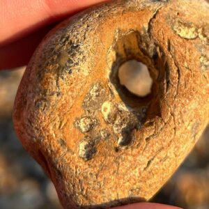 Kizzy Edgell Instagram - A Hag Stone, also known as an adder stone, is a stone that has a naturally occurring hole through it. Such stones were, and sometimes still are, believed to have magical properties. These supposedly include the ability to heal a snake bite, or see through the disguise of a witch or fairy by looking through the hole.