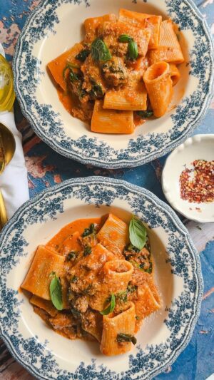 Laura Vitale Instagram - This sausage and spinach pasta in a luscious spicy cream sauce is one of the best dishes I’ve eaten all summer! It has it all, texture, balance and the creaminess is so good! You can sub mascarpone for the cream if you like or even ricotta! It’s so yum!  Recipe below! 

2 tbsp olive oil 
8oz of sausage out of the casing (I did half sweet and half spicy)
2 shallots, sliced 
3 cloves of garlic, minced 
Tap of Calabrian chilis or pinch of hot pepper flakes 
4 tbsp of tomato paste 
About 1 cup of starchy cooking water 
Handful of washed baby spinach 
1/2 cup of heavy cream
Pinch of Italian seasoning 
Plenty of parm
Salt and pepper to taste 
12os of big rigatoni or paccheri