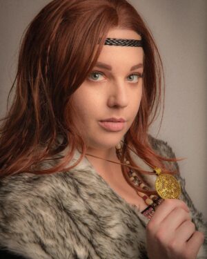 Lindsay Jones Instagram - The photos are in from my second maternity shoot and THEY’RE AWESOME! I wanted to pay homage to Freyja (Freya), Norse goddess of love, fertility, war and death, who is also a mother of two with Odr! Her colors are gold and green, which I implemented into the costume and body paint. Complete with her Brisingamen, feathered cape, sword and shield, she is ready to slay her enemies and her lovers. 
HUGE thank yous to @jonrisinger @texasdelarosa and @andy_blanchard for making this dream of mine a reality! Jon had the brilliant idea to use filters to give them a painted parchment feel. Instagram doesn’t even do these justice. I will be posting more! ❤️
