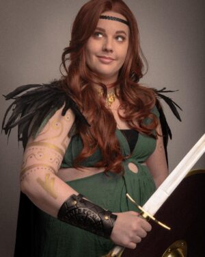 Lindsay Jones Instagram - The photos are in from my second maternity shoot and THEY’RE AWESOME! I wanted to pay homage to Freyja (Freya), Norse goddess of love, fertility, war and death, who is also a mother of two with Odr! Her colors are gold and green, which I implemented into the costume and body paint. Complete with her Brisingamen, feathered cape, sword and shield, she is ready to slay her enemies and her lovers. 
HUGE thank yous to @jonrisinger @texasdelarosa and @andy_blanchard for making this dream of mine a reality! Jon had the brilliant idea to use filters to give them a painted parchment feel. Instagram doesn’t even do these justice. I will be posting more! ❤️