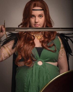 Lindsay Jones Instagram - The photos are in from my second maternity shoot and THEY’RE AWESOME! I wanted to pay homage to Freyja (Freya), Norse goddess of love, fertility, war and death, who is also a mother of two with Odr! Her colors are gold and green, which I implemented into the costume and body paint. Complete with her Brisingamen, feathered cape, sword and shield, she is ready to slay her enemies and her lovers. 
HUGE thank yous to @jonrisinger @texasdelarosa and @andy_blanchard for making this dream of mine a reality! Jon had the brilliant idea to use filters to give them a painted parchment feel. Instagram doesn’t even do these justice. I will be posting more! ❤️