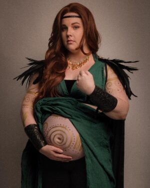 Lindsay Jones Instagram - The photos are in from my second maternity shoot and THEY’RE AWESOME! I wanted to pay homage to Freyja (Freya), Norse goddess of love, fertility, war and death, who is also a mother of two with Odr! Her colors are gold and green, which I implemented into the costume and body paint. Complete with her Brisingamen, feathered cape, sword and shield, she is ready to slay her enemies and her lovers. 
HUGE thank yous to @jonrisinger @texasdelarosa and @andy_blanchard for making this dream of mine a reality! Jon had the brilliant idea to use filters to give them a painted parchment feel. Instagram doesn’t even do these justice. I will be posting more! ❤️