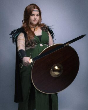 Lindsay Jones Instagram - The photos are in from my second maternity shoot and THEY’RE AWESOME! I wanted to pay homage to Freyja (Freya), Norse goddess of love, fertility, war and death, who is also a mother of two with Odr! Her colors are gold and green, which I implemented into the costume and body paint. Complete with her Brisingamen, feathered cape, sword and shield, she is ready to slay her enemies and her lovers. 
HUGE thank yous to @jonrisinger @texasdelarosa and @andy_blanchard for making this dream of mine a reality! Jon had the brilliant idea to use filters to give them a painted parchment feel. Instagram doesn’t even do these justice. I will be posting more! ❤️