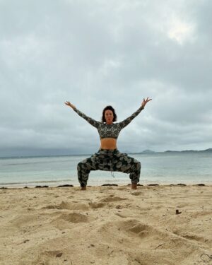 Lynn Collins Instagram - Happy Summer Solstice, Happy Full Moon, and Happy International Day of Yoga!! ☀️🌕🧘🏻‍♀️

…and a reminder to follow @thegoodwooportal and check out the new website link in bio! #thegoodwoo 

Thank you @solidandstriped for the rash guard top and @thesongbirdco for the body chain! 
#summersoltice #internationaldayofyoga #fullmoon #beach #islandlife #bikini