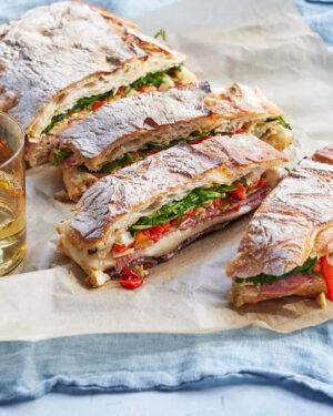 Martha Stewart Instagram - Give your ho-hum picnic sandwich a Martha upgrade. Put this easy grilled sandwich together in the morning and leave it to press under the weight of your trusty cast iron skillet. You'll be amazed at how pressing helps the flavors of olive tapenade, provolone, mozzarella, roasted peppers, marinated artichoke hearts, spicy salami, and baby arugula combine in this hearty sandwich. A quick turn on grill will melt the cheese, then cut the sandwich into portions for serving. Get the recipe at the link in our bio. 📷: @conpoulos, recipe   food styling: @shirabocar, prop styling: @suzie_myers