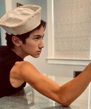 Maximilian Lee Piazza Instagram - swipe 👉 photo inspo: '90s Jean Paul Gaultier sailor ad  
 
Impromptu photo 📸 taken at my grandpa's after discovering his sailor hat from the time he served in the navy 🫡 🇺🇸 70 years ago  
 
 
 #navy #jeanpaulgaultier #couturefashion #fashion #vintagead