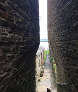 Michael Palin Instagram - Some of The houses at Stromness are so tightly wedged together that they have to shave a bit off the bottom of the building to let people through