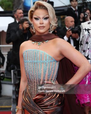 Nicky Doll Instagram - Yes we CANNES ✨

What an absolute pleasure to spend time in Cannes this year. Walking the red carpet with my two absolute icons, with whom we work relentlessly on this little show that does some real good in France and beyond 💅🏼 @daphneburki @kiddysmile we cleared. 

don’t forget to tune in for @dragrace_france season 3 May 31st! 🇫🇷💅🏼

Thank you @france.tv 🫶🏻

Wearing my icon @rochart_design sketched by @farida_kant 
HMU @juliencharlierparis 
Jewelry @gv.jewels_costumes 
Shoes @louboutinworld