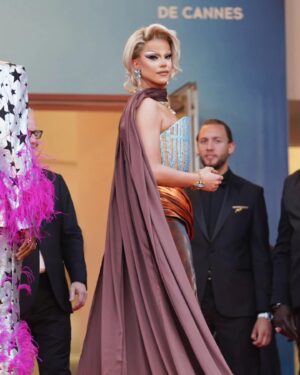 Nicky Doll Instagram - Yes we CANNES ✨

What an absolute pleasure to spend time in Cannes this year. Walking the red carpet with my two absolute icons, with whom we work relentlessly on this little show that does some real good in France and beyond 💅🏼 @daphneburki @kiddysmile we cleared. 

don’t forget to tune in for @dragrace_france season 3 May 31st! 🇫🇷💅🏼

Thank you @france.tv 🫶🏻

Wearing my icon @rochart_design sketched by @farida_kant 
HMU @juliencharlierparis 
Jewelry @gv.jewels_costumes 
Shoes @louboutinworld