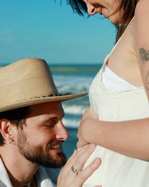 Nico Tortorella Instagram - We’ve got some big news: We’re having another baby!

This era has been all about transition, bending and shifting in order not to break. We left everything familiar to find something new—somewhere the grass really is greener because the sun shines more. We did it. We moved to a place where we can grow food year-round, where we can run barefoot, chase lizards, play in the ocean, and literally stop to smell the flowers. Somewhere we can continue to build our family.

The very day we arrived at our new house, we made a baby. Really, it’s true. It’s funny how, when you commit to dreams and embrace changes, miracles unfold.

Today’s a big day with a lot going on:

- My children’s book ‘Olivette is You’ launches today! @randomhousekids 
- I’m on the wonderful podcast @notskinnybutnotfat which is live right now!
- Also, my album ‘Born.’ drops this Friday, complete with a very special music video all about being pregnant.🔻🔺

Despite all this, seemingly none of that matters. Right now, this moment is a celebration of life at a time when life itself seems the most fragile.

Bethany, thank you for creating the space to continue to grow our family. We are nothing without you. I am constantly in awe of your strength and willingness to expand. And Kilmer Dove, get ready girl—it’s big sister energy from here on out. I love you both. I love all of you. All of it is you.

📷 by @rocco_tortorella