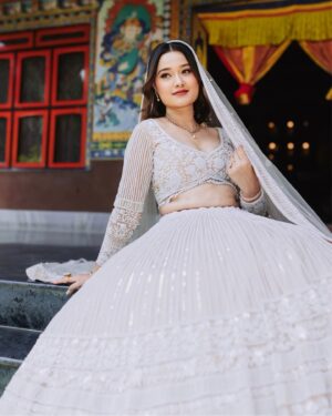 Riyasha Dahal Instagram - Elegance in a snap. 🤍 
.
.
.
.
Wearing: @samrat_couture @samratraiofficial 
MUA: @swechchhya.makeup 
Hairstylist: @glamby_pratikshya 
Assist by: @rajshbibhari_ 
Jewelry: @shree_natraj_jewellers 
Lens: @visions.np