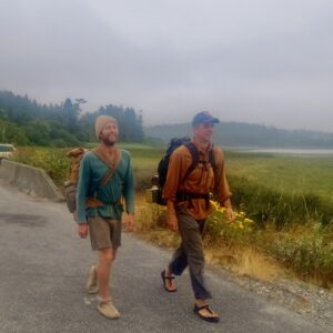 Rob Greenfield Instagram - Hello from the road Dear Friends!

I am 95 miles into my walk down the Pacific Coast from Canada to Los Angeles.

This is already the longest walk on roads that I have ever done by far. I didn’t do any training. I just started walking…

So far it has been much more challenging than expected. I’ve walked barefoot for 35 miles and the rest has been done with my homemade, handmade wool and leather shoes. 
This has been a very educational experience in simple and sustainable living as far as taking on an endurance endeavor with solely natural fiber, homemade clothing. 

My legs and feet have been quite sore and after a couple days I wasn’t sure what I was going to do or how I’d even make it… But I’ve found my walking legs with more confidence now. 
I’m currently working on felting thick wool inserts and sewing on thicker leather soles that won’t wear through as quickly. I’m taking a few rest days in Port Townsend right now.

I have not been alone. From the border 6 friends joined me for the first few miles. 
My Dear Friend Brent @societyofsmiles called me up just before I was scheduled to begin and we are walking the whole state of Washington together. It has been a very beautiful experience and I’m very grateful for Brent’s support! When I first decided I wanted to do this walk, Brent 
Immediately came in mind for a partner!

We have been supported by numerous people along the way, being welcomed into their homes and offered meals. In a time when I see so much separation and polarization I am feeling my connection with humanity deepened. We don’t have a support vehicle, but I wouldn’t call this self-supported either. This is a community-support walk. 

The journey continues from here through Washington, Oregon and California along the Pacific Coast, mostly along roads. All are welcome to join and I will be hosting gatherings in the weeks and months ahead (Port Townsend event next week). If you are interested in getting involved in any way, I have shared the route, schedule and information on how to support on the website (link in bio). There is also a newsletter and Facebook group you are welcome to join.

Love,
Robin