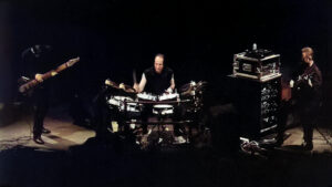 Robert Fripp Instagram - On this day in 1998, ProjeKct Two (Trey Gunn, Adrian Belew, and Robert Fripp) were performing at Palookaville, Santa Cruz. [Excerpts and download at dgmlive.com, link in bio and stories]
A much more pensive-sounding tuning of the air which opens the gig is made darker still when Gunn joins in rumbling and snorting at the lower end of his instrument. Trey is a complete beast on House - no wonder the audience burst into applause at the conclusion of a particularly raging outing by him.

As the boys embark on Search For Planet Zarg, space really is the place as notes stretch into a multi-coloured psych-rock drench-out. Ditto House in which Gunn wails away like there’s no tomorrow - the ebb and flow becoming increasingly wilder as the track progresses. Ade locks down the groove nice and solid. Light ConstruKction is still at this stage very loose. The mutant jazz that begins Low Life On Sagittarius A quickly evaporates with Fripp producing the wafts of strange smoky notes that you sometimes hear on a Threnody, perhaps recalling the sombre atmospheres at the beginnings of the concert.

Once again, it’s interesting to hear Thrush still in the process of finding itself as Fripp delivers a yearning solo that sounds like it’s being beamed from another galaxy altogether. The second set ramps up the intensity that’s been on a rolling boil throughout the first.

There’s not such a cautious sense to this gig as perhaps was in evidence the previous evening. Trey certainly appreciated the difference in the atmosphere between the first and second gigs. “Now this is more like it! A great crowd, and a good sound. It all makes life worth living again. Also, it was a standing audience (Ventura was a seated theater.) I think we've found that a standing audience gets us going more. A very mixed crowd as well. A very un-Crimson crowd (read: lots of women and younger surfer-dude types.)”
[Notes by Sid Smith]

#treygunn #adrianbelew #robertfripp #projekcttwo #kingcrimson
