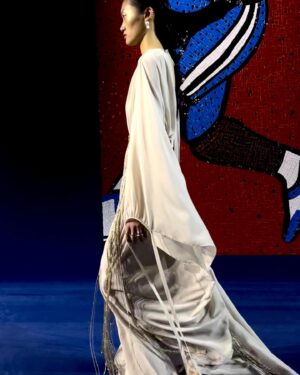 Rosamund Pike Instagram - Exceptionally beautiful time at the Rodin museum watching the @dior Haute Couture show. Mirrored and embroidered wall panels by the late great Faith Ringgold depicted athletes in all disciplines and sports, providing counterpoint to the physiques of models draped and tailored in exquisite pleating, metallic jersey, feathers and ribboned fabric. Movement was an essential part of this show. And I have tried to capture bodies in motion. Architecture of the body celebrated by fine architecture of clothes. Maria Grazia has outdone herself today. A shining show!!! My hair and makeup done by @valeriaferreiramakeup and @davidebarbieri_