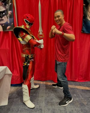 Russell Curry Instagram - My @rangerstopandpop 2024 wrap up! 

Thank you to all of the fans and the amazing organizers for making my first Ranger Convention such an incredible time! 

Thank you to all my castmates and other fellow Rangers for being so gracious, kind and ready for some shenanigans! The Power Rangers family really is a FAMILY 🙏🏼

And last but certainly not least, thank you to @trippin_over_toys aka Tyler aka the best volunteer right hand man I could've asked for! He went absolutely above and beyond in making sure things went as smoothly as possible for myself and everyone who came to our booth. AND he even took all these dope candid pics so I could have even more memories of my first con 🙌🏼

If you're into collectibles, especially action figures, give his page a follow. Tons of great stuff on there! 

I can't wait for the next one! See you all soon 😉

PS Tyler didn't ask me to shout him out, he's just an awesome dude and deserves the love!