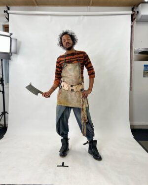 Samba Schutte Instagram - Today’s (Our) Flag (Means Death) Day, and many of you have asked for deets on my character Roach in Season 2🪳 Here you are🏴‍☠️ 
Details on the costumes during fittings and after weathering and aging. It was great collaborating with Costume Designer Gypsy and being able to implement my own backstory. For the Red Flag fit I wanted him to have a headband because a chef never gets hairs on his meals. Unless it’s on the menu, or you’re serving the British👨🏾‍🍳
For his new fit, Roach got to have more jewelry this season because he became a better pirate. I chose 3 rings. The Lion to symbolize the Atlas Mountains where he hails from. The 2 headed Snake, because you have to always watch your back as a pirate. And a Celtic looking ring, because Roach has a tender spot. Like with his mother’s scarf. And of course his talisman necklace that he always wears, with every costume🪬At first it was gonna be a long sleeve shirt, but Jenkins wanted me to show off my sexy dessert making arms. Rightly so…..💪🏾
On his belt he had meat hooks, his cleaver as a weapon and of course, a wooden spoon for self defense🥄
I’ve never worn Doc Martens before and let me tell you, I don’t know how people smaller than me do it, those things weigh a ton each! Now imagine running on the beach in them👀
More deets in stories but I loved every minute of dressing up as and playing this chaotic dude🫶 
#ourfladmeansdeath #ofmd #ofmdseason2 #roach #cosplay #bts