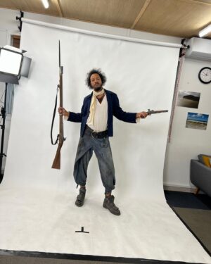 Samba Schutte Instagram - Today’s (Our) Flag (Means Death) Day, and many of you have asked for deets on my character Roach in Season 2🪳 Here you are🏴‍☠️ 
Details on the costumes during fittings and after weathering and aging. It was great collaborating with Costume Designer Gypsy and being able to implement my own backstory. For the Red Flag fit I wanted him to have a headband because a chef never gets hairs on his meals. Unless it’s on the menu, or you’re serving the British👨🏾‍🍳
For his new fit, Roach got to have more jewelry this season because he became a better pirate. I chose 3 rings. The Lion to symbolize the Atlas Mountains where he hails from. The 2 headed Snake, because you have to always watch your back as a pirate. And a Celtic looking ring, because Roach has a tender spot. Like with his mother’s scarf. And of course his talisman necklace that he always wears, with every costume🪬At first it was gonna be a long sleeve shirt, but Jenkins wanted me to show off my sexy dessert making arms. Rightly so…..💪🏾
On his belt he had meat hooks, his cleaver as a weapon and of course, a wooden spoon for self defense🥄
I’ve never worn Doc Martens before and let me tell you, I don’t know how people smaller than me do it, those things weigh a ton each! Now imagine running on the beach in them👀
More deets in stories but I loved every minute of dressing up as and playing this chaotic dude🫶 
#ourfladmeansdeath #ofmd #ofmdseason2 #roach #cosplay #bts