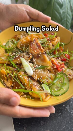 Saransh Goila Instagram - Trust me doston, this is the ULTIMATE way to eat dumplings in my opinion! Who would’ve thought that momo could be added in a salad right 🤯🙂‍↔️. Dumpling salad has been trending on the Internet for weeks & I knew I had to try it using momos! This dumpling salad recipe is inspired by @hettymckinnon and @sebscrispyclub I’d love for them to try the Indian momos version! Would you try this at home? Let me know in the comments! 
.
. 
Dumpling Salad 

2 tbsp Light soy sauce 
1 tbsp Peanut butter 
2 tsp Chili oil 
Juice of 1/2 a lemon 
2 Garlic cloves, grated 
A few coriander leaves 
Mix well 

1 tbsp Oil 
Place 10 momos 
1/4 cup Water 
Cover & cook till all the water has evaporated 
& the momos are crispy 

Add them to a bowl 
Chopped cherry tomatoes 
A handful of spring onions 
Sliced cucumbers 
Add the dressing 
& mix well 

Delishaaas 🤤