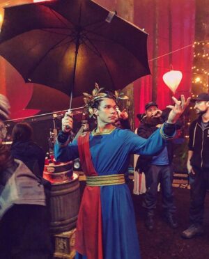 Sean Depner Instagram - This is, by far, one of the best costumes I’ve ever gotten to wear! Anybody else think fashion should give technicolored togas another shot? 
This pic is from episode 13 season 4, The Ides of March. The lines “Friends, romans, countrymen, lends me your beers” and “oh thou bleeding piece of earth” were both lines we added on the day and are references to Shakespeare’s Julius Caesar, his play about Caesar’s assassination on the ides of March.
The more you know 🌈
📸 @karterhol