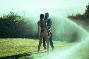 Skylar Grey Instagram - Filming in the sprinklers was like playing a video game! Elliott constantly dodging the water so the camera didn’t get drenched! Side note, is it just me or does this scene have some Happy Gilmore “happy place” vibes????? 😂
