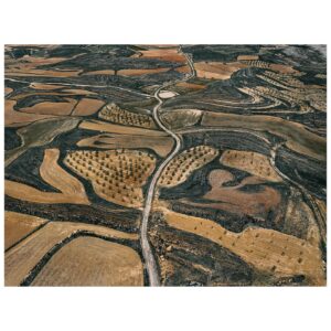 Tom Hegen Instagram - In this aerial series, I explore the stunning landscape of agricultural fields in central Spain. Over centuries, Spanish farmers transformed the landscape into a patchwork of abstract art. They adapted to the rugged topography by carving tracks, fields and plantations into the terrain.

Even though the soil is quite fertile, cultivating the fields is challenging due to increasingly low rainfall and extreme heat. For that reason, the fields are organized in terraces to prevent rainwater from flowing off. Some fields are still cultivated, while others have been abandoned due to excessive labour and low yields.

Seen from the air, the landscape resembles a subtle arrangement of blood cells, ordered into a patterned carpet covering the surface.

I’m interested in finding the most abstract forms of human-altered landscapes—places where the transition from photography to painterly images is fluid. However, farmers on the ground are the actual designers of the images, supposedly with an economic rather than an artistic intention. I see myself as the observer, curating their work into artworks with a subtle eye.