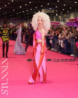 Trinity the Tuck Instagram - What an incredible weekend at @rupaulsdragcon UK! Thank you all who came to visit me at my booth! It was my pleasure to talk to each of you! Thank you to my team of Tuck Support who helped facilitate such a professional and easy work space! I’ll see you at the next one ! Hair by the incredible @baehmbaehmwigs suit embellished by @natalia_at_nite and the amazing blue jacket by @mr_riegillio . Jewels by @ampedaccessories . Photo credit by @stunnin.mag and @gettyimages