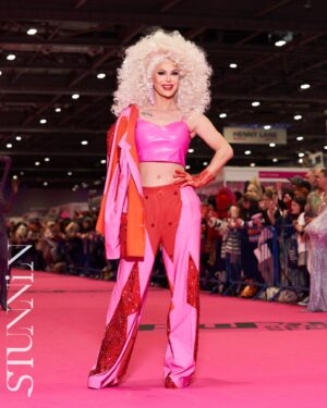 Trinity the Tuck Instagram - What an incredible weekend at @rupaulsdragcon UK! Thank you all who came to visit me at my booth! It was my pleasure to talk to each of you! Thank you to my team of Tuck Support who helped facilitate such a professional and easy work space! I’ll see you at the next one ! Hair by the incredible @baehmbaehmwigs suit embellished by @natalia_at_nite and the amazing blue jacket by @mr_riegillio . Jewels by @ampedaccessories . Photo credit by @stunnin.mag and @gettyimages
