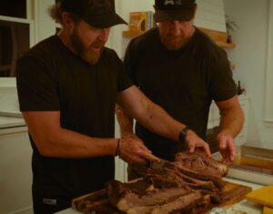 Tyler Grey Instagram - Two Fake SEALs is finally filming content! @ajbuckley and I just spent a week creating our first videos for our new show and podcast! On the show you will learn about everything in a diverse range of topics from preparedness and off-grid living to overlanding and even how to cook the perfect brisket! On the podcast we will have a wide range of guests from actors to comedians and yes even some real Navy SEALs! We are very excited to be working on this, it is a lot of fun and we are  very excited to go on this ride together! Go to @twofakeseals to follow us for updates on the launch dates! Until then, you can check us out in the final season, number 7 of SEAL Team only on Paramount Plus!