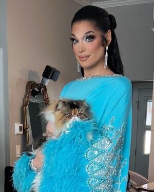 Valentina Instagram - Moments before slipping into slipping the gown. Fully drenched in 3 different perfumes, then after in the gown while holding my little baby girl Cholula. The most beautiful moment getting ready from home with friends, also, I think this look would have made María Félix proud 💕

Makeup: @shablamgela 
Hair: @walliecruz 
Gown: @georgeshobeika
