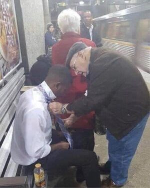 Vincent Laresca Instagram - This young man was on his way to a job interview and having trouble with his tie. The woman in red noticed and nudged her husband. She then blocked the view of others so the kid wouldn’t be embarrassed. It’s the kindness and respect for each other that will overcome our differences. Our sense of community should never be lost. #community