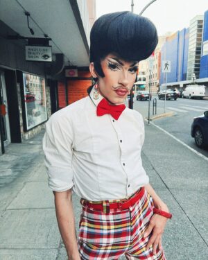 Vivian Vanderpuss Instagram - Do these pants make my legs look lithe? 
Some fab little shots from Wigstock during Pride week @theviciouspoodle with Woofie (@seanburgundy ) 
It was the third show of the day so we went heavy with the filter ha! 
✨
I made this wig a long time ago and it’s been sitting on my shelf waiting for the perfect character. I was a game show host, a biker, a little Freddie and a phantom in one eve. I wasn’t sure (with how big this hat was) how it would hold up doing 5 numbers real quick but it was perfectly fine! God bless hairspray and a good tease! 
✨
The hair is inspired by Wooden Sword Ryu from Shaman King! 
.
.
.
.
#drag #dragking #dragkingmakeup #vivianvanderpuss #wig #dragwig