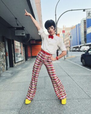 Vivian Vanderpuss Instagram - Do these pants make my legs look lithe? 
Some fab little shots from Wigstock during Pride week @theviciouspoodle with Woofie (@seanburgundy ) 
It was the third show of the day so we went heavy with the filter ha! 
✨
I made this wig a long time ago and it’s been sitting on my shelf waiting for the perfect character. I was a game show host, a biker, a little Freddie and a phantom in one eve. I wasn’t sure (with how big this hat was) how it would hold up doing 5 numbers real quick but it was perfectly fine! God bless hairspray and a good tease! 
✨
The hair is inspired by Wooden Sword Ryu from Shaman King! 
.
.
.
.
#drag #dragking #dragkingmakeup #vivianvanderpuss #wig #dragwig