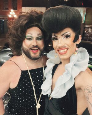 Vivian Vanderpuss Instagram - Do these pants make my legs look lithe? 
Some fab little shots from Wigstock during Pride week @theviciouspoodle with Woofie (@seanburgundy ) 
It was the third show of the day so we went heavy with the filter ha! 
✨
I made this wig a long time ago and it’s been sitting on my shelf waiting for the perfect character. I was a game show host, a biker, a little Freddie and a phantom in one eve. I wasn’t sure (with how big this hat was) how it would hold up doing 5 numbers real quick but it was perfectly fine! God bless hairspray and a good tease! 
✨
The hair is inspired by Wooden Sword Ryu from Shaman King! 
.
.
.
.
#drag #dragking #dragkingmakeup #vivianvanderpuss #wig #dragwig