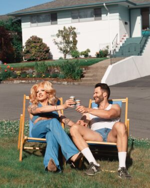 Vivian Vanderpuss Instagram - Crack open a cold one for dad. ☀️ 
.
These are the first of a series of pictures taken by Socrates D. styled by me. I wanted to capture those fab vintage vintage vibes! Thanks for the lawn chairs @ejmears !
💇🏼‍♀️hair by me
👙Top by me 
👖 vintage Viceroy from @cheersvintagecollective 
#vivianvanderpuss #canadasdragrace #70s #vintage #vibes #fathersday #denim #summer #solstice