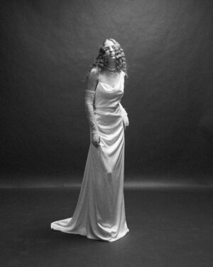 Vivienne Westwood Instagram - First seen on the red carpet, the Minerva is a non-corseted, backless floor length gown with a sensual silhouette. Introduced in its bridal form for the 2020 collection, it features a twisted asymmetric neckline, with softly falling fabric drapes across the body, extending to an elegant train. For 2024 the Minerva is available in heavy silk satin, offered in a Pearl White tone. ⁠
⁠
Available in our London, New York, Los Angeles, Paris and Milan boutiques.⁠
⁠
Photography by @kingsley_ifill⁠
Video by @kyle.keese⁠
Styling by @florahuddart⁠
⁠
#VWBridal #WestwoodBridal