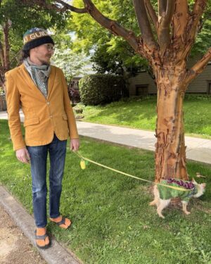 Annette O'Toole Instagram - I love this photo of my son-in-law Kevin. He is wearing a scarf and Tabi socks made by me and a hat made by my daughter Nell. Their dog Wilton is wearing a sweater Nell made. It’s such a Knitting Family photo.