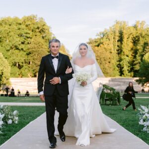 Connar Franklin Instagram - #OTMExclusive 💍 Our September cover is here, featuring #OTMBride @connarfranklin and @aaroncarpenter’s wedding—which took place exactly one year ago today at George Vanderbilt’s @biltmoreestate. 🥂 Connar and her father walked down the 200-foot-long aisle, as a 20-piece orchestra 🎻 played “Invisible String” by @TaylorSwift. “I was freaking out walking down in front of everyone, but the second I saw Aaron, it felt like it was just us two,” the bride reflects. “There was a moment when my leg almost gave out. I broke my toe two-and-a-half hours before, but I insisted on wearing my four-inch heels. It was a challenge but nothing a little numbing cream and love in the air couldn’t fix!”🩹🤍

Stay tuned as Connar is taking over our IGS later today, and go to the 🔗 in bio to see more of her and Aaron’s wedding. 

📷: @josevilla
Planning: @samkoma.world
📍: @biltmoreestate
Beauty: @jentioseco @flawlessairbrush @tombachik
💌: @katewisemancreative
Decor: @whitedoorevent
Watercolor Artist: @alyssa_faye_simpson
🎶: @entertainofficial

#OTMWedding #wedding #thebiltmoreestate #biltmoreestate #biltmorewedding #northcarolinawedding #weddinginspiration #eliesaab #daniellefrankel  #connarfranklin #aaroncarpenter #camerondallas