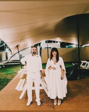 Jenny Lewis Instagram - big news from the @postalservicemusic euro tour!  not only did we return to the UK, spain & portugal after 21 years to play for oodles of folks but after ten years of eating zero gluten 
in paris i chomped many croissants & several baguettes and felt totally great. 
sea change moment for your gal !
also, @jimmytamborello and i went to Tangier 
and stayed at the beautiful @villamabrouka 
thanks to @gq for featuring it in the mag almost a year ago.  i cut it out and put it on my refrigerator and manifested this amazing trip. 
i read burroughs & bowles and the 
splendid and the vile and got a paint sample from the very cool staff at the villa 
so that i can bring a little bit of morocco back to the canyon.  madrid was amazing and bumping into @harrystyles at the fest was a total unexpected highlight !  i moved into the @hotelsamourparis for a few nights and felt right at home. 
also, hanging with  @joshuaradin @annakloots & @zachbraff was so fun & now 
this song will forever be in my head 
cue 
les champs-elysées 
one last @postalservicemusic show to go 
😭😭😭😭
and only three more shows to conclude the JOY’ALL era. 
it’s been a busy and joyful year & @bobbyrhubarblewis and i thank you 
and say 
BLESS!
cool 📸 by @saladjockey