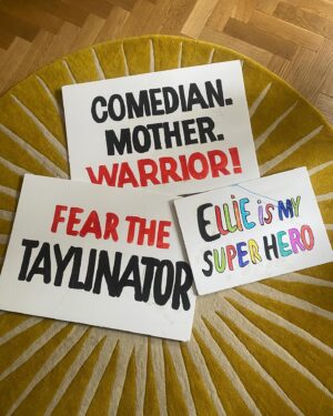 Ellie Taylor Instagram - Gladiators Drop! Such a fun day with such a lovely bunch. Sometimes you gotta do hard things, like wearing Lycra on TV eight months after having a baby - my camel toe sends its regards.
 
•the happiest moment of my life 💒 👰 
•epic signs my husband and daughter made
•cosplaying as a PE teacher 
•my beautiful family 
•Viper. Never. Breaking. Character - give this guy a BAFTA
•the highest compliment - my daughter wearing my top whilst scoffing coco pops the next morning. I have never seen her so utterly chuffed in life as when I went over to see her at the end of the show, holding the trophy. Turns out all it takes to receive her pride is receiving multiple blows to the head and nearly dying running up a backwards travellator. It’s the little things 💓🫠