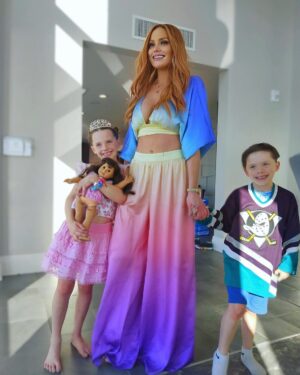 Kathryn Dennis Instagram - Happy 8th birthday to my baby chica! We had a @limitedtoo inspired party. So many classics. We made lava lamps friendship bracelets and tie-dye scrunchies. Blowup chairs flower pillows, mom pulled out all the stops. Just look at my baby girl and her American Girl doll both in @loveshackfancy  Don’t gloss over the Mighty Ducks jersey that Saint is rocking. Traditions 💗 It was a wonderful day. Every day with them is bc I’m home 🙏  #BFFL #bestfamilyforlife 
☮️💗😋