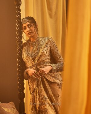 Krithika Babu Instagram - From the heart of the Aratrika Collection, where twilight’s glow meets the artistry of tradition, comes the Aratrika Jacket. 

Crafted with care, this luxury piece embodies the sacred beauty of evening rituals, adorned with intricate gold embroidery on delicate beige net. Each stitch reflects the essence of Aratrika—a tribute to the ancient tradition of lighting lamps as day fades into night. With ornate detailing and an opulent finish, this jacket stands as a timeless masterpiece of elegance and heritage.

Discover our all new couture collection “Aratrika” online at www.houseofthreestudio.com and our flagship store on Vittal Mallya Road, Bangalore.

Model @krithikababu

Photographer @abinvrghz

Stylist @queenandro_

Jewellery @bhimagold.official

Carpets @carpetkingdomindia

Creative direction @sounaksenbarat
@anushyamsundar
@houseofthreestudio

Decor @houseofthreeinteriors
Produced by @nevrmint.productions
.
#heritagefashion #timelesselegance #goldembroidery #eveningwear #fashionartistry #traditionalwear #bangalorefashion #couture #luxuryfashion #aratrikacollection