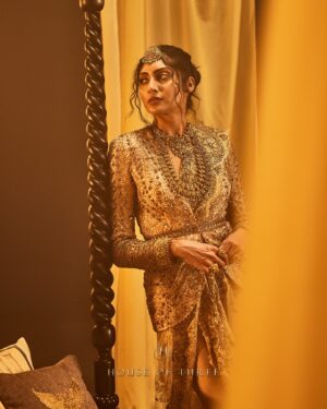 Krithika Babu Instagram - From the heart of the Aratrika Collection, where twilight’s glow meets the artistry of tradition, comes the Aratrika Jacket. 

Crafted with care, this luxury piece embodies the sacred beauty of evening rituals, adorned with intricate gold embroidery on delicate beige net. Each stitch reflects the essence of Aratrika—a tribute to the ancient tradition of lighting lamps as day fades into night. With ornate detailing and an opulent finish, this jacket stands as a timeless masterpiece of elegance and heritage.

Discover our all new couture collection “Aratrika” online at www.houseofthreestudio.com and our flagship store on Vittal Mallya Road, Bangalore.

Model @krithikababu

Photographer @abinvrghz

Stylist @queenandro_

Jewellery @bhimagold.official

Carpets @carpetkingdomindia

Creative direction @sounaksenbarat
@anushyamsundar
@houseofthreestudio

Decor @houseofthreeinteriors
Produced by @nevrmint.productions
.
#heritagefashion #timelesselegance #goldembroidery #eveningwear #fashionartistry #traditionalwear #bangalorefashion #couture #luxuryfashion #aratrikacollection
