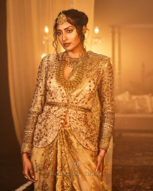 Krithika Babu Instagram - From the heart of the Aratrika Collection, where twilight’s glow meets the artistry of tradition, comes the Aratrika Jacket. 

Crafted with care, this luxury piece embodies the sacred beauty of evening rituals, adorned with intricate gold embroidery on delicate beige net. Each stitch reflects the essence of Aratrika—a tribute to the ancient tradition of lighting lamps as day fades into night. With ornate detailing and an opulent finish, this jacket stands as a timeless masterpiece of elegance and heritage.

Discover our all new couture collection “Aratrika” online at www.houseofthreestudio.com and our flagship store on Vittal Mallya Road, Bangalore.

Model @krithikababu

Photographer @abinvrghz

Stylist @queenandro_

Jewellery @bhimagold.official

Carpets @carpetkingdomindia

Creative direction @sounaksenbarat
@anushyamsundar
@houseofthreestudio

Decor @houseofthreeinteriors
Produced by @nevrmint.productions
.
#heritagefashion #timelesselegance #goldembroidery #eveningwear #fashionartistry #traditionalwear #bangalorefashion #couture #luxuryfashion #aratrikacollection
