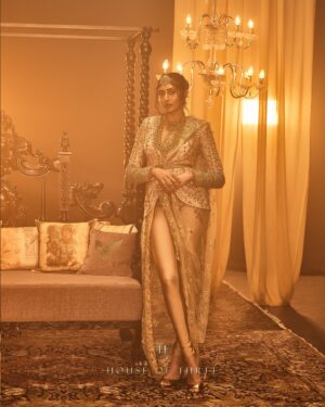 Krithika Babu Instagram - From the heart of the Aratrika Collection, where twilight’s glow meets the artistry of tradition, comes the Aratrika Jacket. 

Crafted with care, this luxury piece embodies the sacred beauty of evening rituals, adorned with intricate gold embroidery on delicate beige net. Each stitch reflects the essence of Aratrika—a tribute to the ancient tradition of lighting lamps as day fades into night. With ornate detailing and an opulent finish, this jacket stands as a timeless masterpiece of elegance and heritage.

Discover our all new couture collection “Aratrika” online at www.houseofthreestudio.com and our flagship store on Vittal Mallya Road, Bangalore.

Model @krithikababu

Photographer @abinvrghz

Stylist @queenandro_

Jewellery @bhimagold.official

Carpets @carpetkingdomindia

Creative direction @sounaksenbarat
@anushyamsundar
@houseofthreestudio

Decor @houseofthreeinteriors
Produced by @nevrmint.productions
.
#heritagefashion #timelesselegance #goldembroidery #eveningwear #fashionartistry #traditionalwear #bangalorefashion #couture #luxuryfashion #aratrikacollection