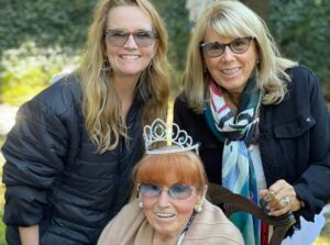 Lea Thompson Instagram - This is a week. Our beloved matriarch Pam had a stroke and passed away a few days later and before we could completely comprehend, the tragedy of the LA fires overwhelmed us.  Today we laid her to rest. My mother-in-law lived with us for the better part of 10 years. We took care of her many heath needs and she listened to our stories. And I will miss her for the rest of my life. She was a survivor of scleroderma, cancer, sepsis, blood clots, heart problems and wounds. But her spirit kept us on our toes. Her humor made her so lovable. As you can see she had a loving family and we are so grateful she got out before LA caught on fire. Mother of my husband. Grandmother to my fierce daughters. I hope you know you left your mark, Pam. You were loved.