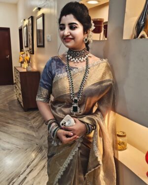 Mahalakshmi Shankar Instagram - The saree from @raagaclothing features a rich golden sheen, giving it a luxurious and festive appeal.The intricate lace border adds a delicate touch of sophistication.This tissue fabric  have a soft and smooth texture, enhancing its overall grandeur which is Perfect for traditional events, weddings, or special occasions.

The layered necklace with emerald-green and white stones from @chennai_jazz stands out beautifully, complementing the golden saree. The choker necklace with pearls adds a regal touch, making the ensemble more opulent. Matching earrings and bangles tie the whole look together seamlessly. The jewelry enhances the ethnic appeal and highlights the overall attire.

Blouse designed and stitched by @lakshmi_lv14