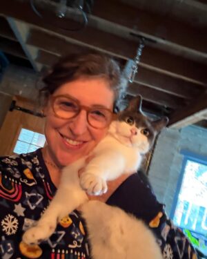 Mayim Bialik Instagram - These Little Sleepies Chanukah PJs are so incredibly soft that I thought my softest cat would love posing with me in them—we’d feel like we were one. 🤦‍♂️ Spoiler: She did not enjoy the photo shoot, but the pajamas are just as cozy and soft as Addie! @littlesleepies