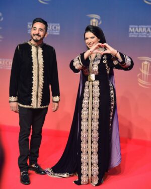 Mounia Lamkimel Instagram - @marrakechfilmfestival 
مع العمر @naamanadil 

حطيت الالبوم لي وصلني كااامل حيث ماعرفتش شنو نختار🫣 شكرا بزاااااف @tendancevision 
بغيت نقول شكرا لادارة المهرجان على حفاوة الاستقبال شكراً للاعلام المغربي على التتبع والمساندة 🇲🇦♥️
شكرا العزيزة الغالية @zor.creations  على اللبسة الهماوية لي تمتعت وانا لابساها ورغم الظروف الصحية والانشغالات إلا انك كنتي متمكنة من حرفتك ولبستيني أنا وعادل على أكمل وجه
شكرا من القلب اخويا وصديقي المتميز @halim_barakat_official لي ماكنتيق إلا فيه ولي شرف على الماكياج والشعر فوقت خرااافي وعطى نتيجة حبييييييتها😌♥️