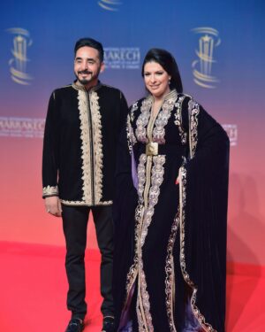 Mounia Lamkimel Instagram - @marrakechfilmfestival 
مع العمر @naamanadil 

حطيت الالبوم لي وصلني كااامل حيث ماعرفتش شنو نختار🫣 شكرا بزاااااف @tendancevision 
بغيت نقول شكرا لادارة المهرجان على حفاوة الاستقبال شكراً للاعلام المغربي على التتبع والمساندة 🇲🇦♥️
شكرا العزيزة الغالية @zor.creations  على اللبسة الهماوية لي تمتعت وانا لابساها ورغم الظروف الصحية والانشغالات إلا انك كنتي متمكنة من حرفتك ولبستيني أنا وعادل على أكمل وجه
شكرا من القلب اخويا وصديقي المتميز @halim_barakat_official لي ماكنتيق إلا فيه ولي شرف على الماكياج والشعر فوقت خرااافي وعطى نتيجة حبييييييتها😌♥️