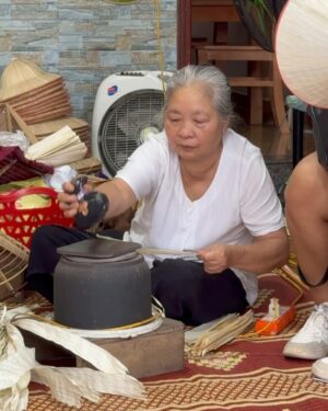 Nazanin Amiri Instagram - Workshop for making Vietnamese hats in one of the villages of Vietnam 🇻🇳(part 1 )location (Chuong hat village)
The process of making traditional Vietnamese conical hats (known as “Non La”) involves several steps:

1. **Material Collection**: Palm leaves or bamboo are used for the structure, and natural or synthetic thread for binding.

2. **Drying**: Leaves are dried to ensure they can be shaped and are durable.

3. **Base Preparation**: A bamboo or wooden ring forms the base of the hat.

4. **Weaving and Binding**: The dried leaves are woven around the base, often using thread to secure them.

5. **Shaping**: The hat is carefully shaped to ensure it fits properly and is symmetrical.

6. **Decoration**: Sometimes decorative elements like fabric or colored threads are added.

7. **Final Touches**: The hat is checked for quality, ensuring it’s both functional and visually appealing.

These hats are lightweight, protective, and a significant cultural symbol in Vietnam.
@nazaninamiri_official 
#vietnam #culture